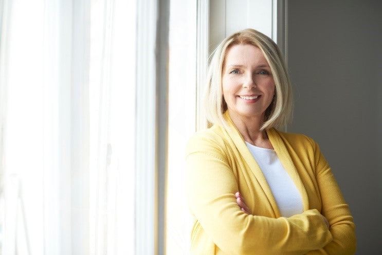 woman standing next to windows