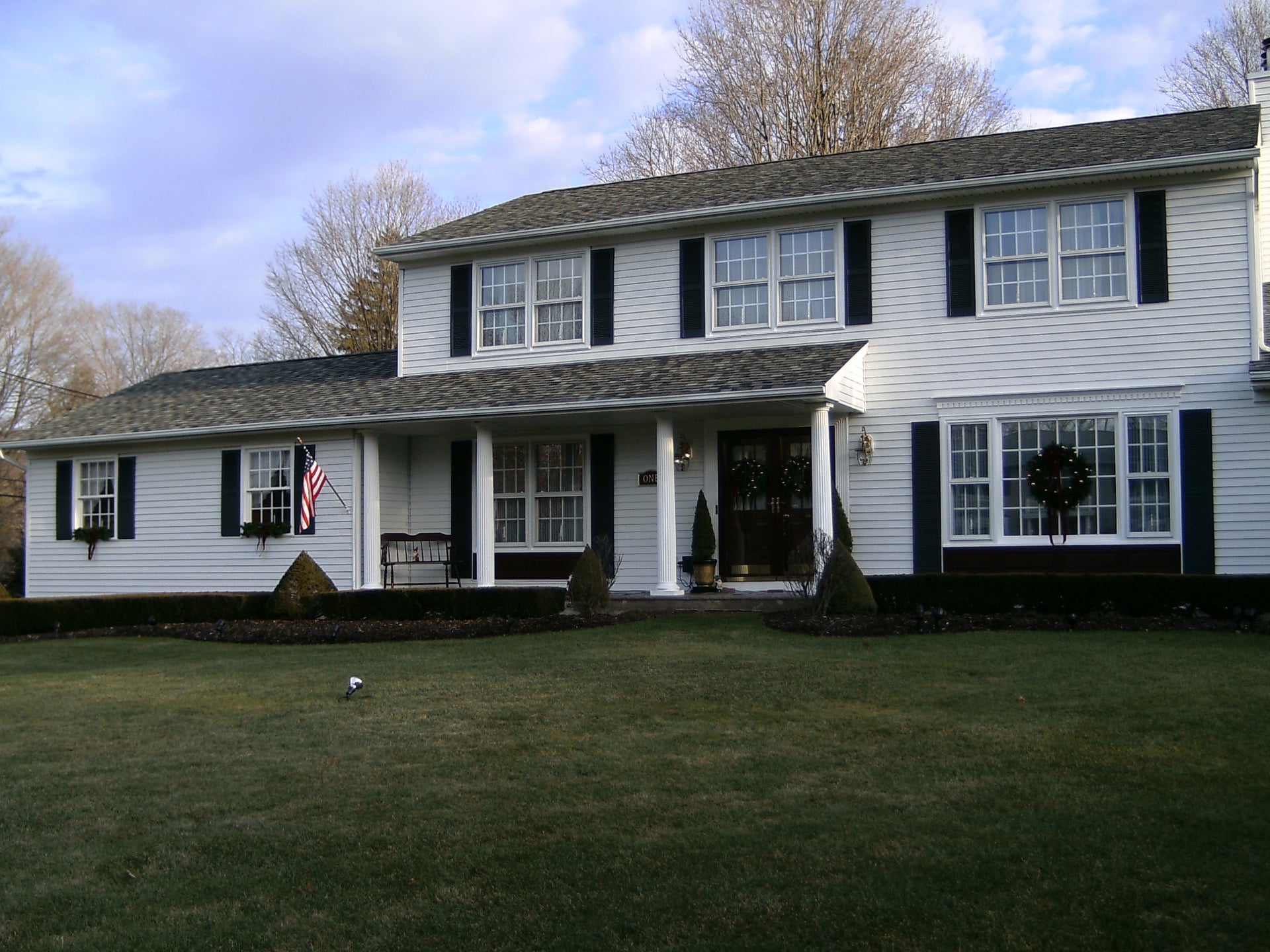 Large house with white vinyl window grilles installed