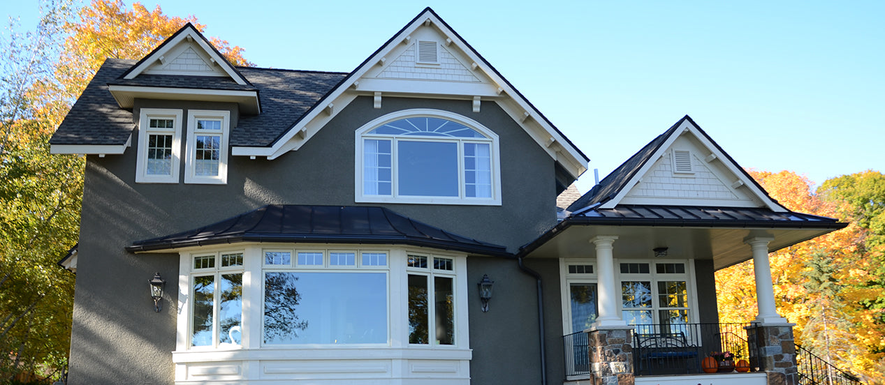 Large home with Colonial and curved window grilles.